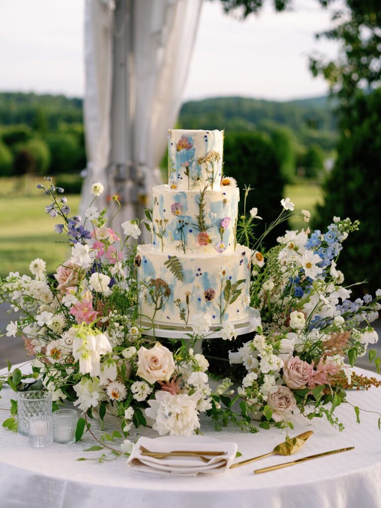 Botanical-inspired wedding cake under the clear tent at The Market at Grelen.